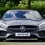 Front view of a luxury Mercedes-Benz AMG against a natural backdrop.